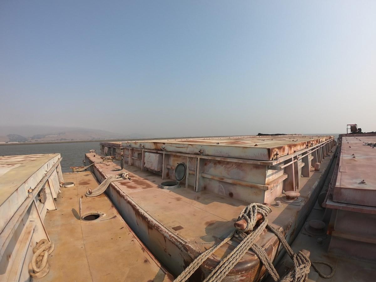 a wooden boat on a dock aboard BARGES Yacht for Sale