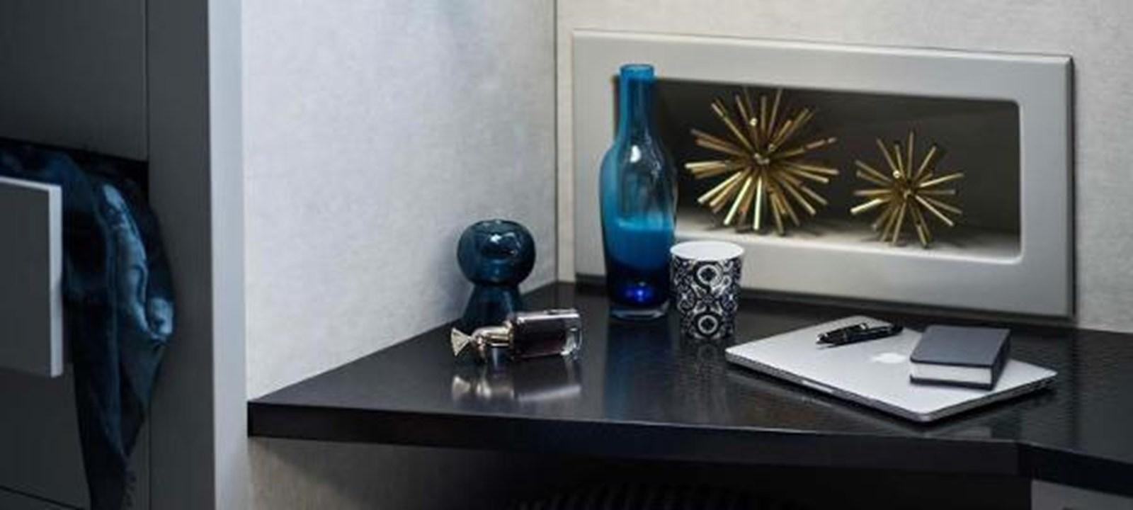 a desk with a phone and a lamp on it aboard JAMADHAR Yacht for Sale