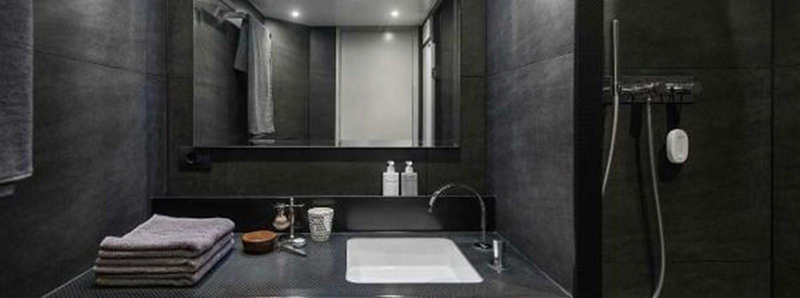 a bathroom with a large mirror aboard JAMADHAR Yacht for Sale