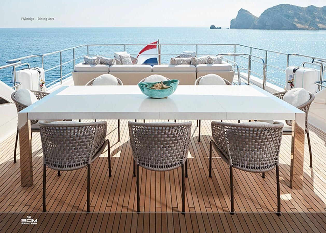 a table with chairs and a boat on it aboard PRINCESS 30M Yacht for Sale