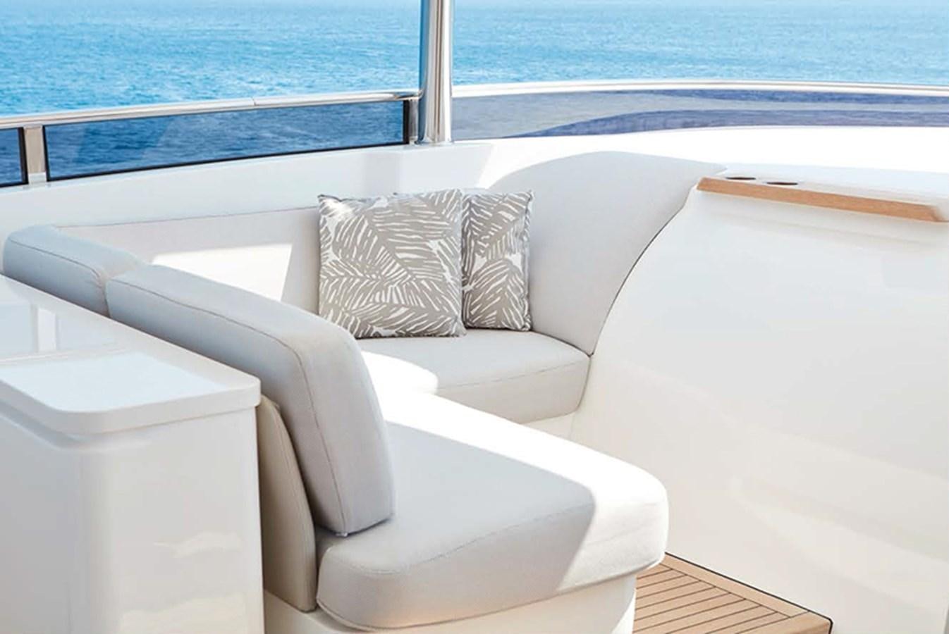 a white couch with pillows on it aboard PRINCESS 30M Yacht for Sale