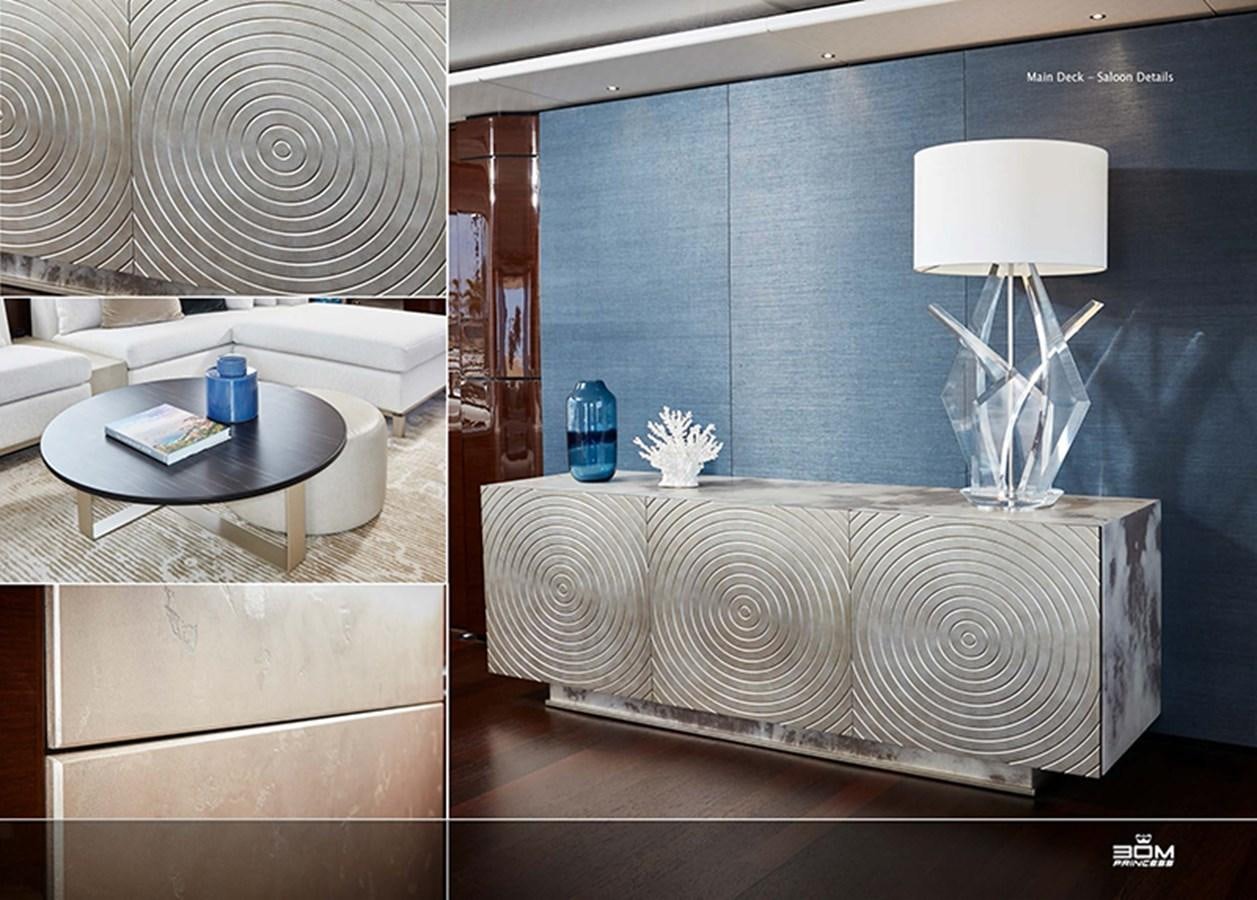 a room with a white bed and a table with a lamp on it aboard PRINCESS 30M Yacht for Sale