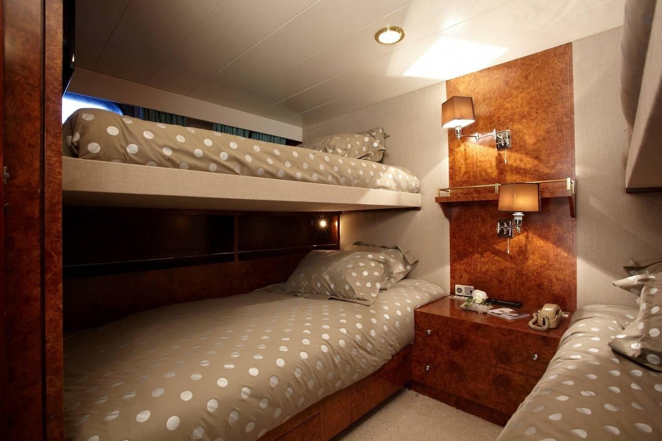 a bedroom with a bed and a shelf aboard QUEEN SOUTH Yacht for Sale