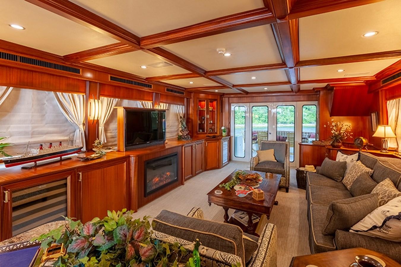a living room with a fireplace aboard RHAPSODY Yacht for Sale