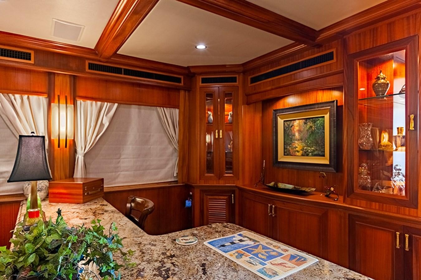 a room with a table and a lamp aboard RHAPSODY Yacht for Sale