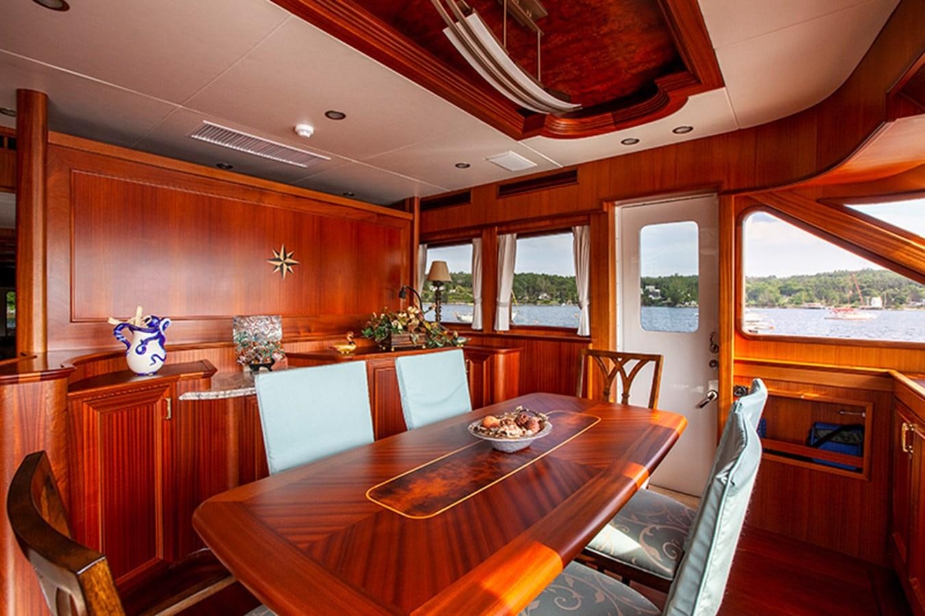 a dining table in a house aboard RHAPSODY Yacht for Sale