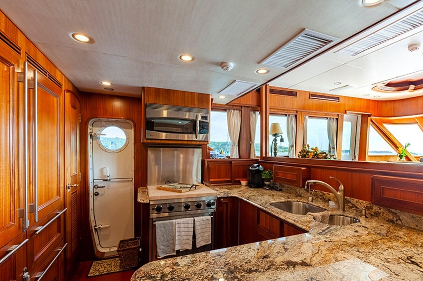 a kitchen with wooden cabinets aboard RHAPSODY Yacht for Sale