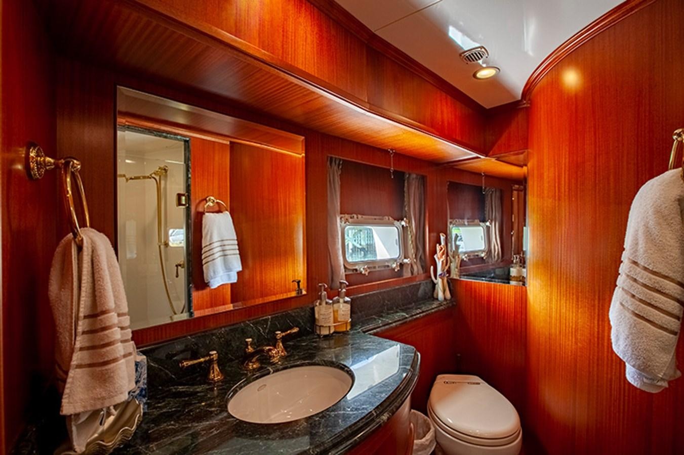 a bathroom with orange walls aboard RHAPSODY Yacht for Sale