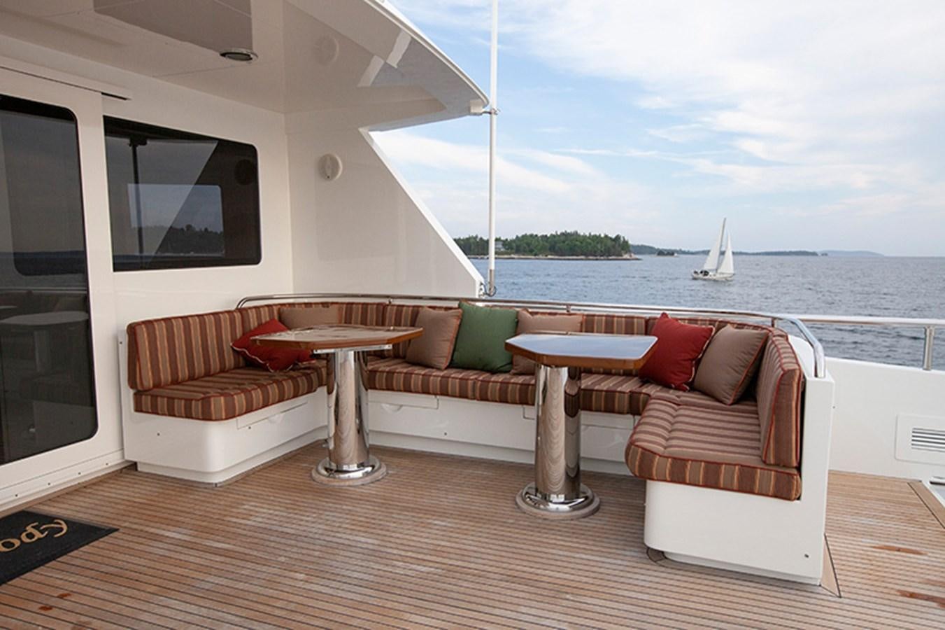 a living room with a boat in the water aboard RHAPSODY Yacht for Sale