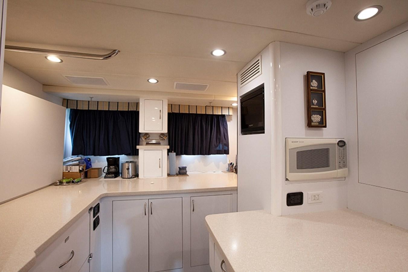 a kitchen with white cabinets aboard RHAPSODY Yacht for Sale
