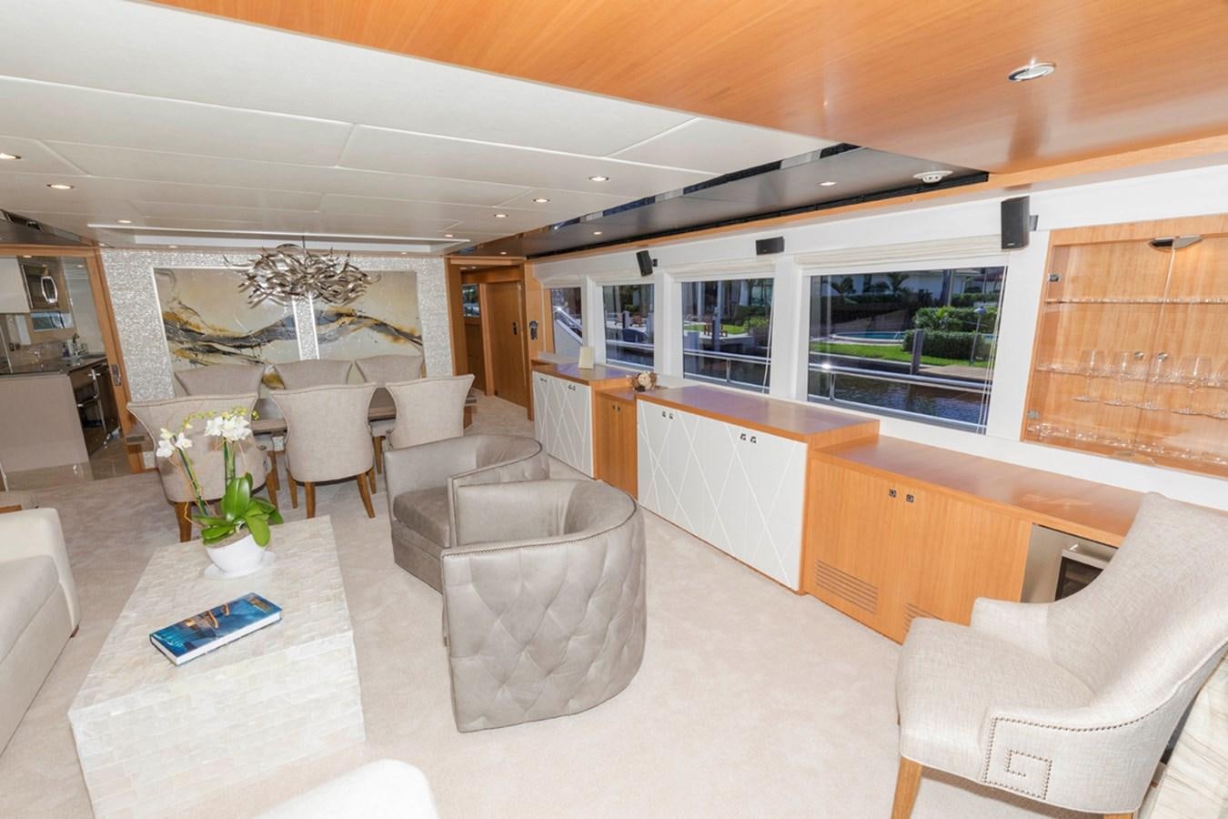 a room with a table chairs and a window aboard DUMB ASS Yacht for Sale