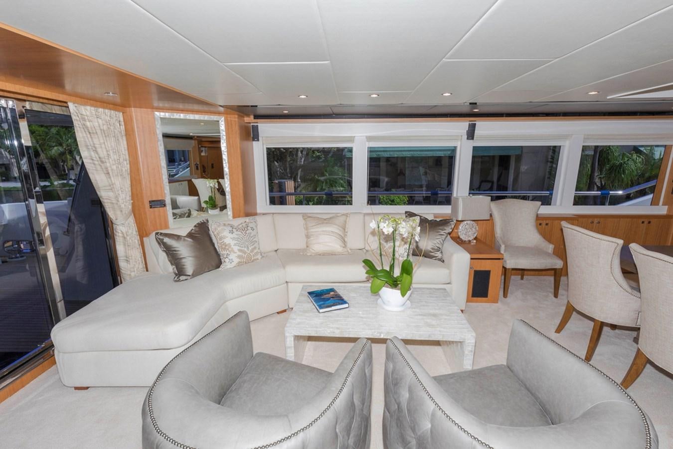 a living room with a table and chairs aboard DUMB ASS Yacht for Sale