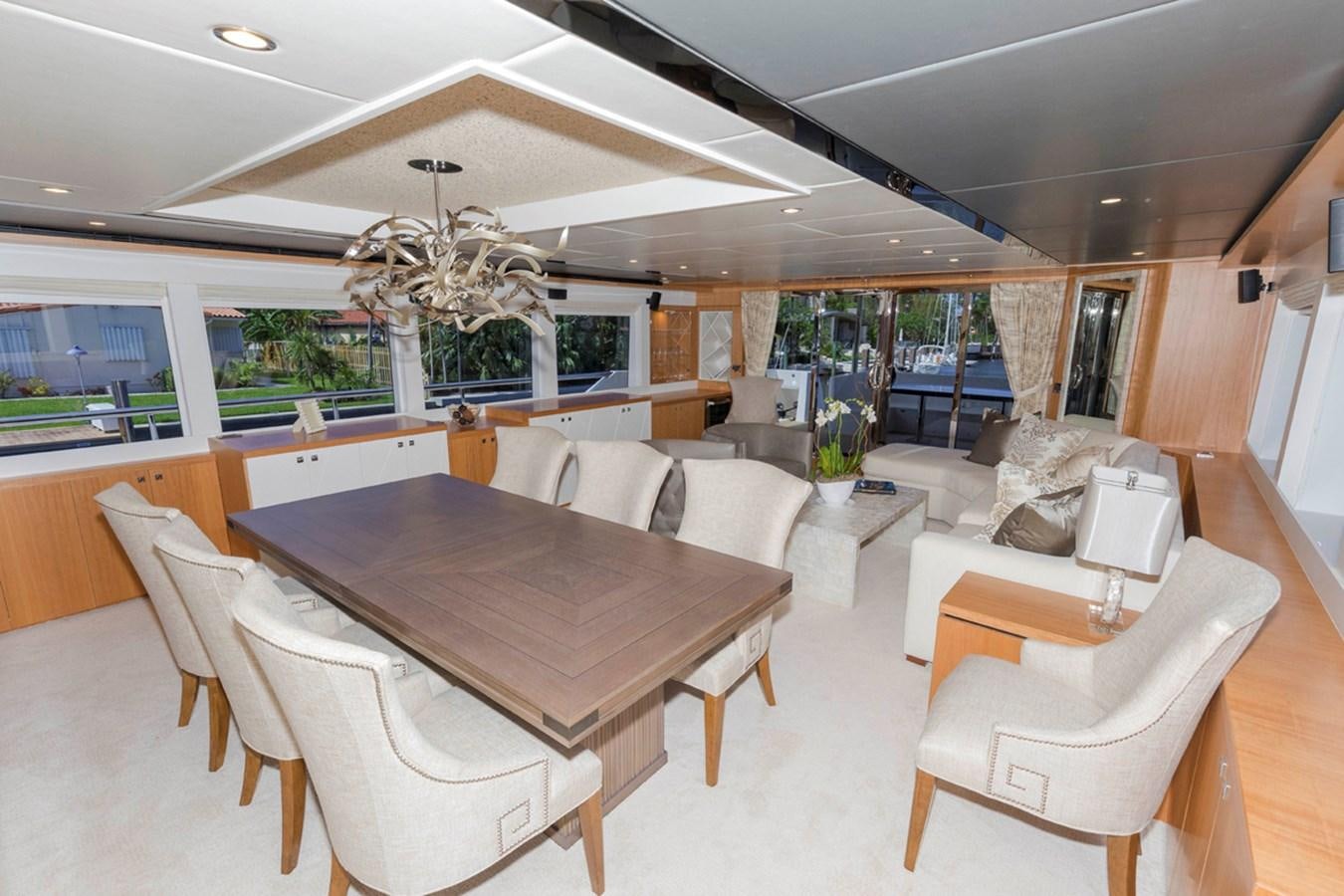 a large room with a table and chairs aboard DUMB ASS Yacht for Sale