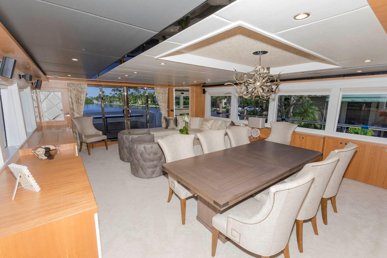a large room with tables and chairs aboard DUMB ASS Yacht for Sale