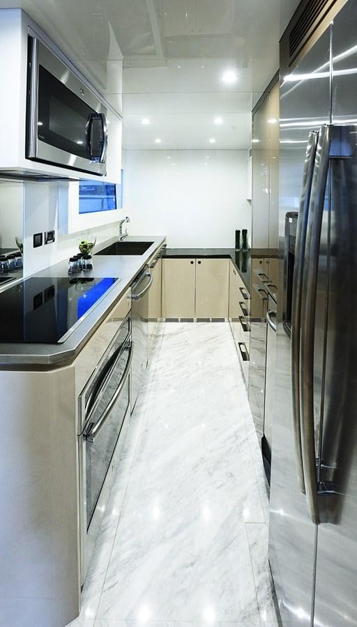 a kitchen with a stainless steel refrigerator aboard DUMB ASS Yacht for Sale