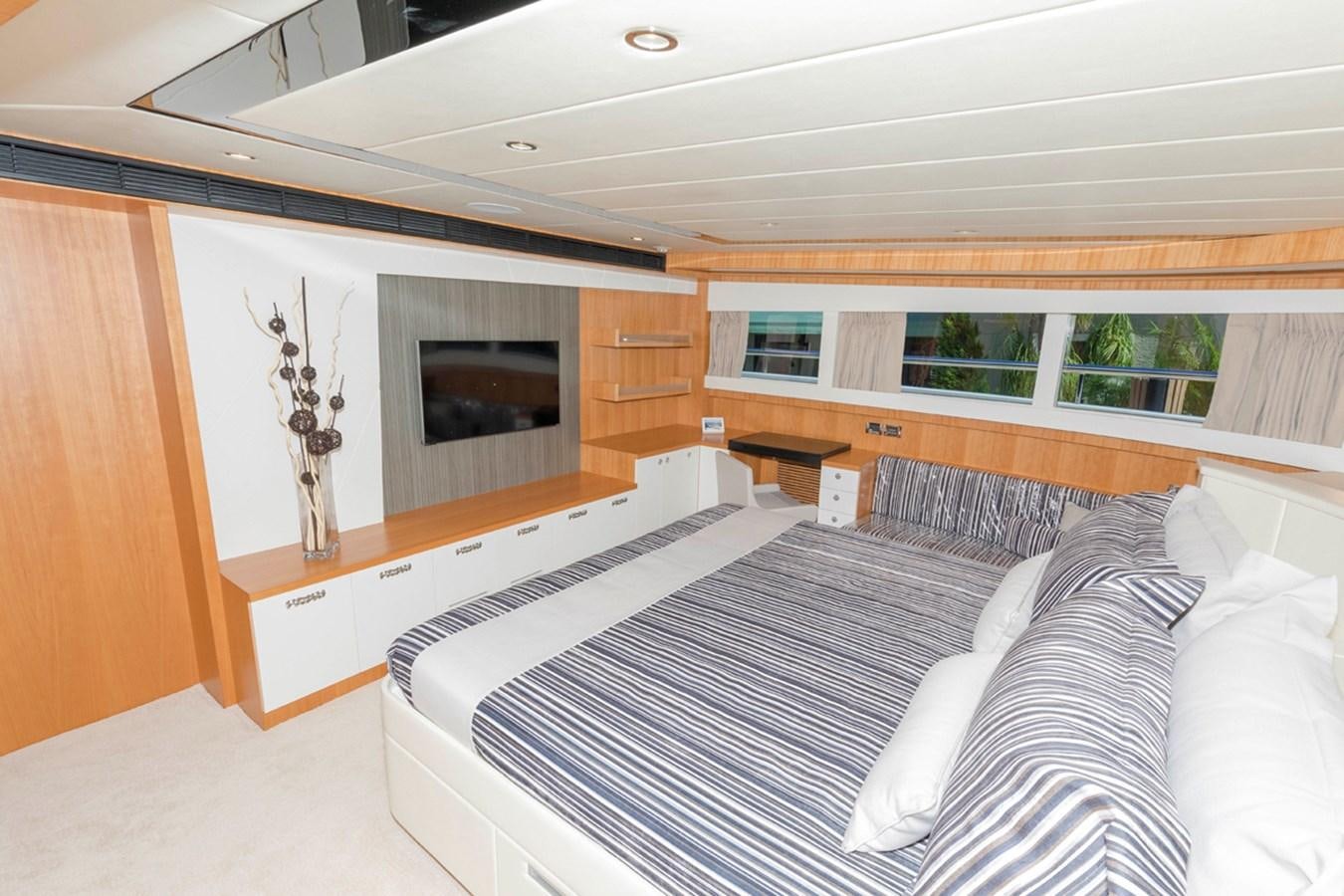 a room with a bed and a fireplace aboard DUMB ASS Yacht for Sale