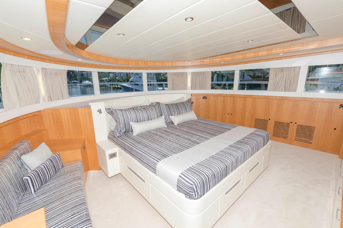 a room with a bed and a couch aboard DUMB ASS Yacht for Sale