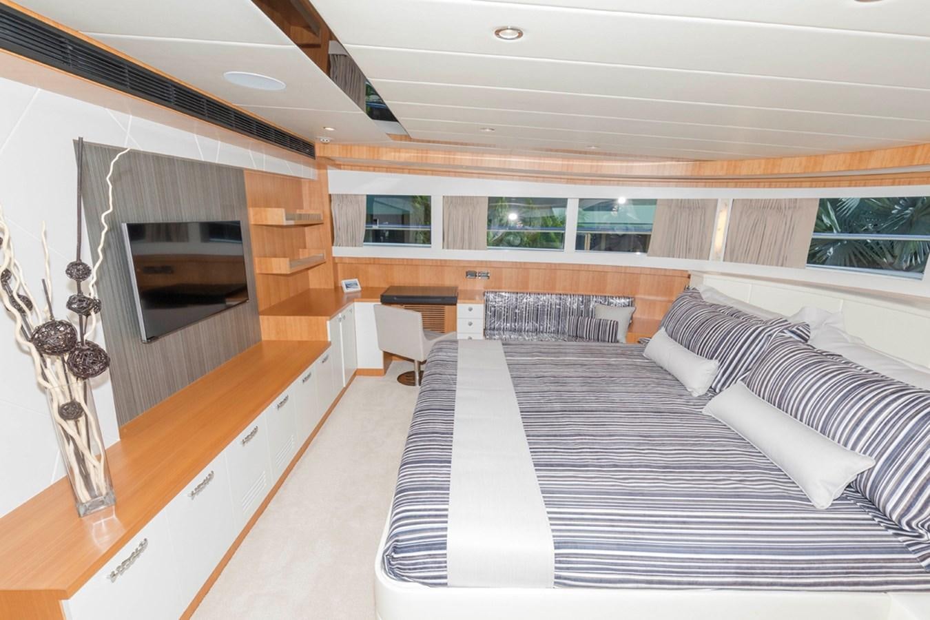 a room with a bed and a television aboard DUMB ASS Yacht for Sale
