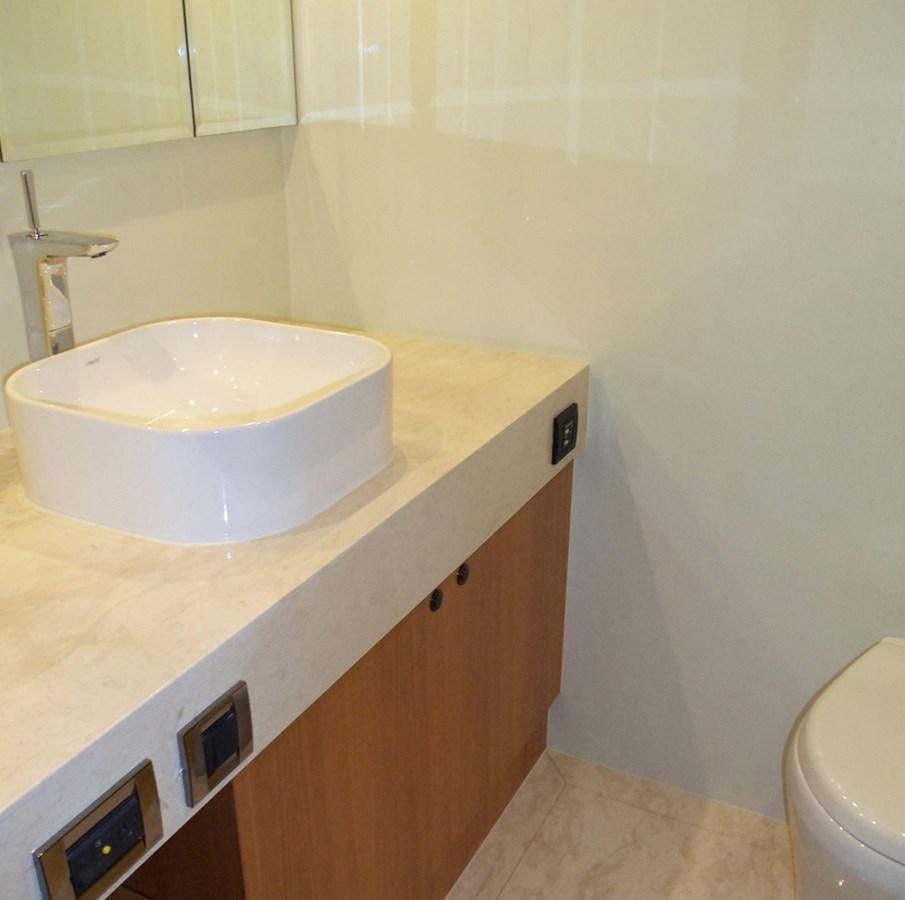 a bathroom with a sink and a toilet aboard DUMB ASS Yacht for Sale