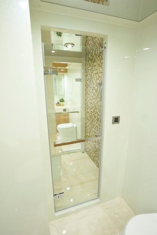 a bathroom with a glass shower aboard DUMB ASS Yacht for Sale