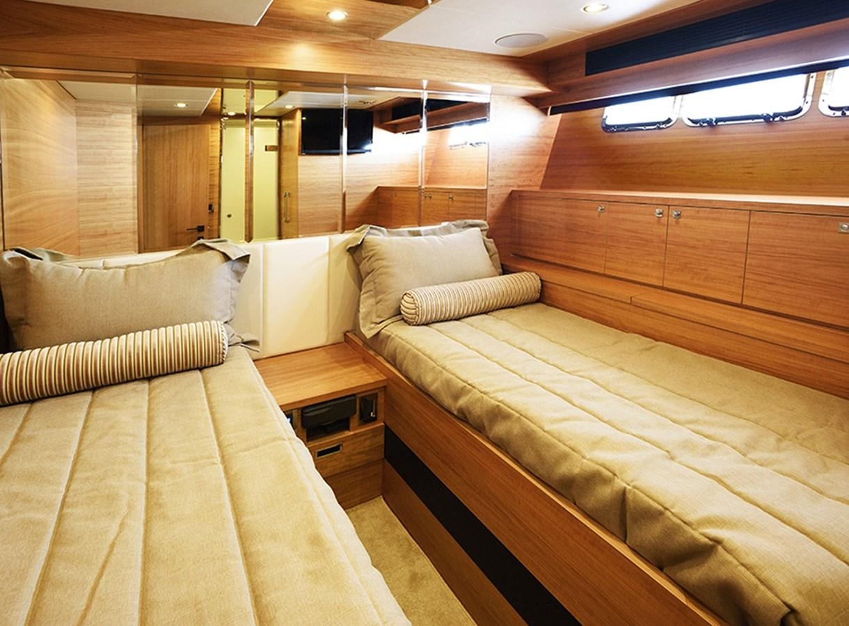 a room with a bed and a wood wall aboard DUMB ASS Yacht for Sale