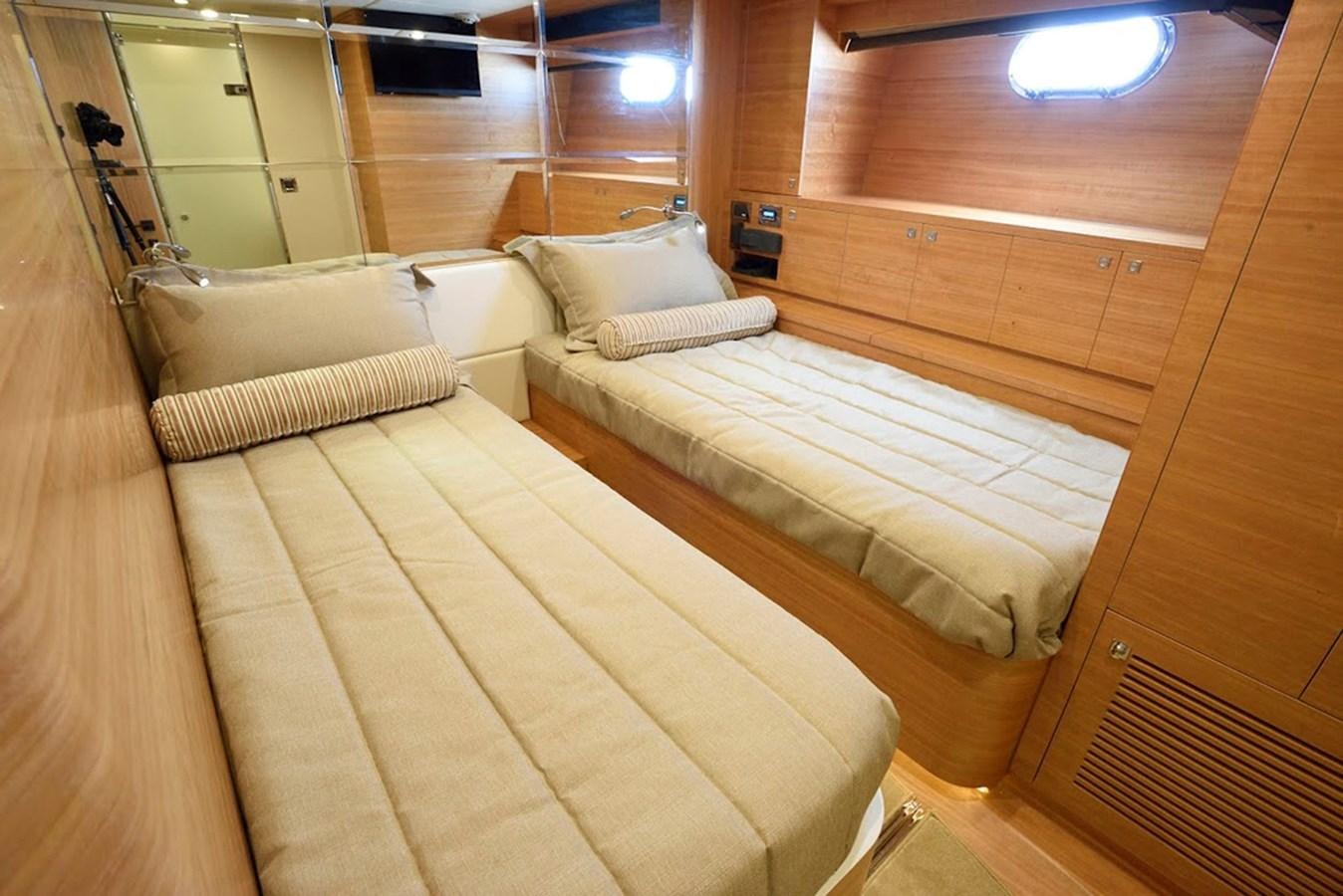 a room with a bed and a mirror aboard DUMB ASS Yacht for Sale