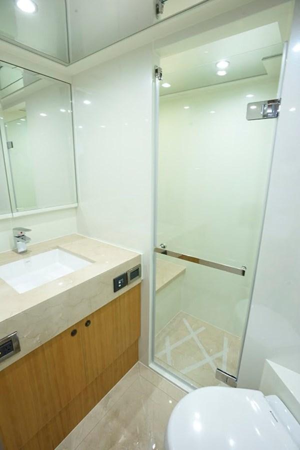 a bathroom with a glass shower door aboard DUMB ASS Yacht for Sale