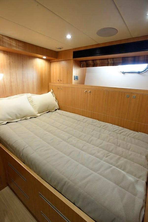 a bed with white sheets aboard DUMB ASS Yacht for Sale