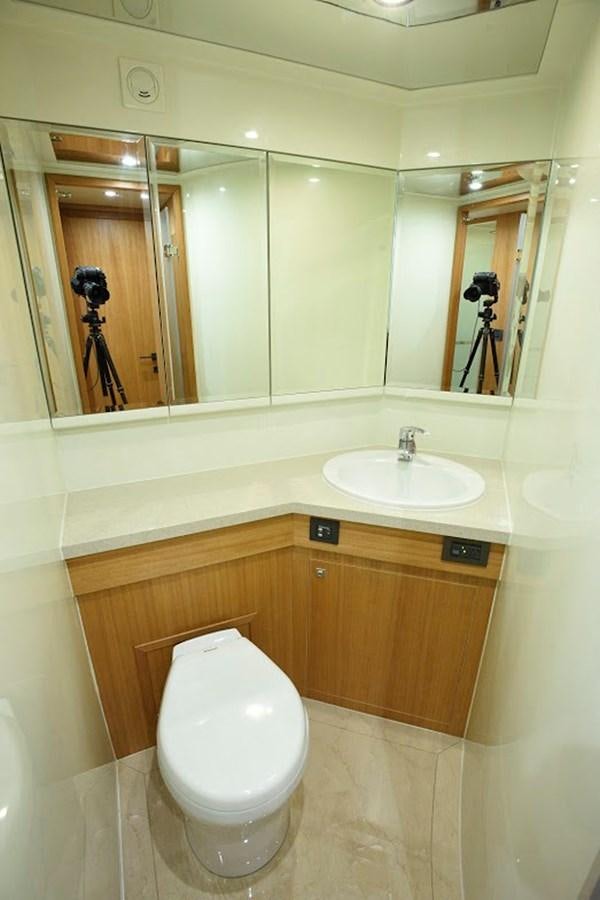 a bathroom with a toilet and a sink aboard DUMB ASS Yacht for Sale