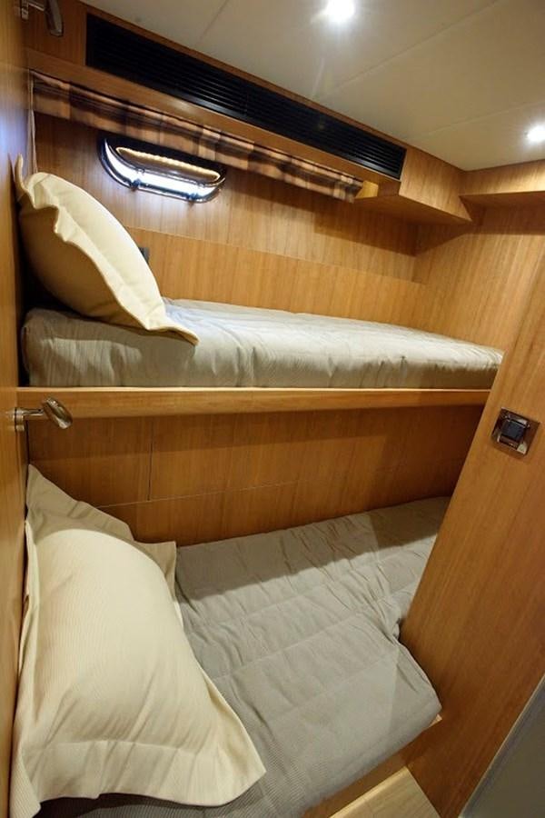 a bed with white sheets aboard DUMB ASS Yacht for Sale