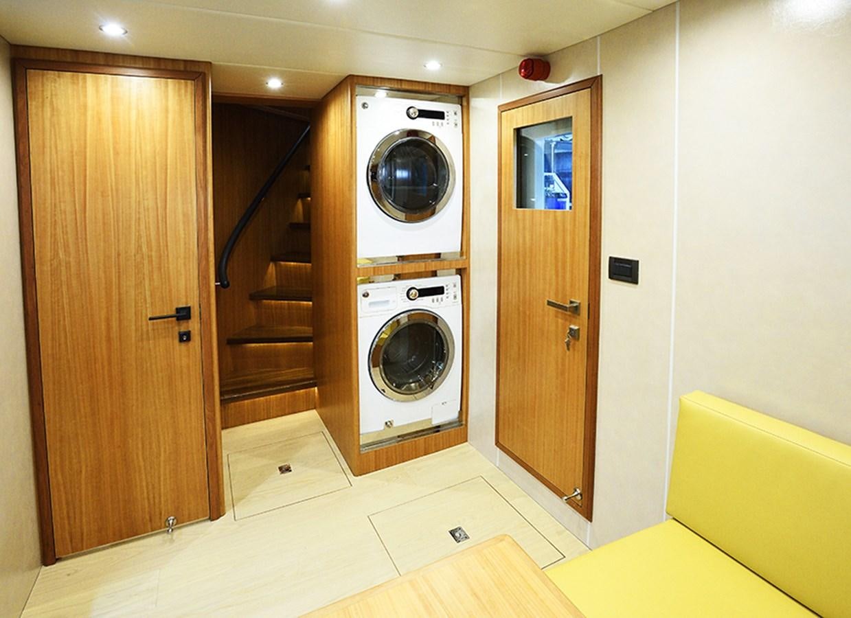 a room with a washing machine and a closet aboard DUMB ASS Yacht for Sale
