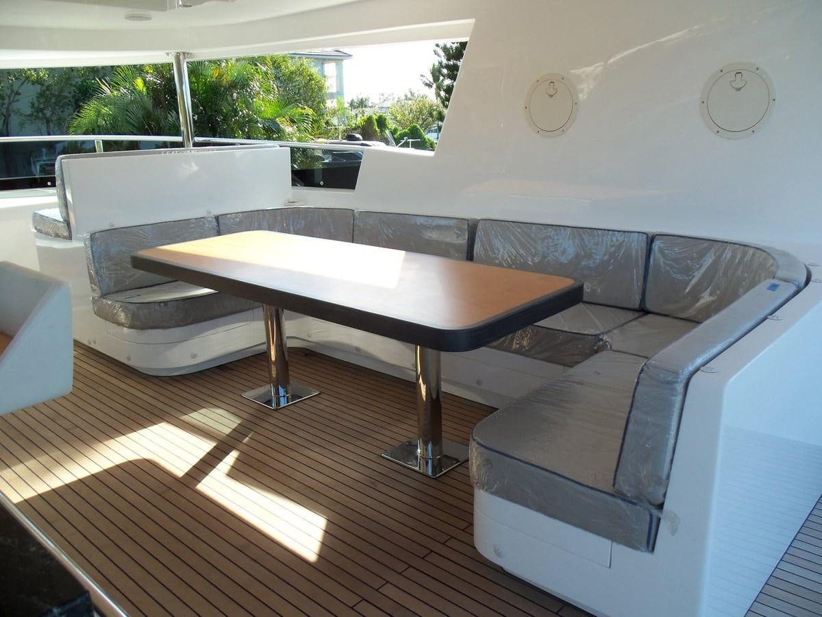 a room with a table and couches aboard DUMB ASS Yacht for Sale