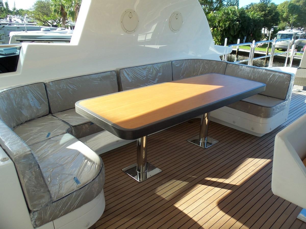a table and chairs on a patio aboard DUMB ASS Yacht for Sale