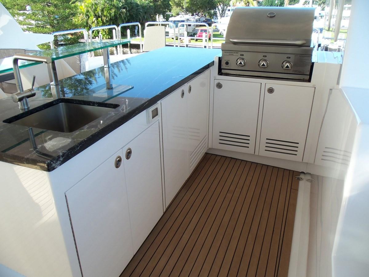 a kitchen with a stove and a sink aboard DUMB ASS Yacht for Sale