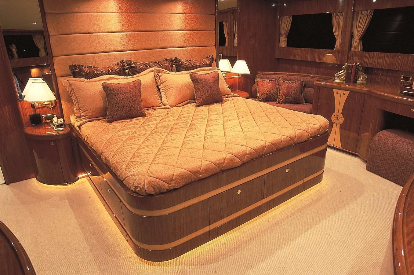 a bed with a wooden frame aboard JOHNSON 93 SKYLOUNGE Yacht for Sale