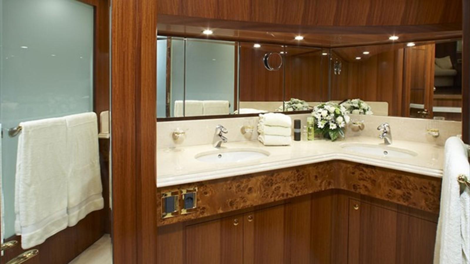 a bathroom with a countertop sink and mirror aboard JOHNSON 93 SKYLOUNGE Yacht for Sale