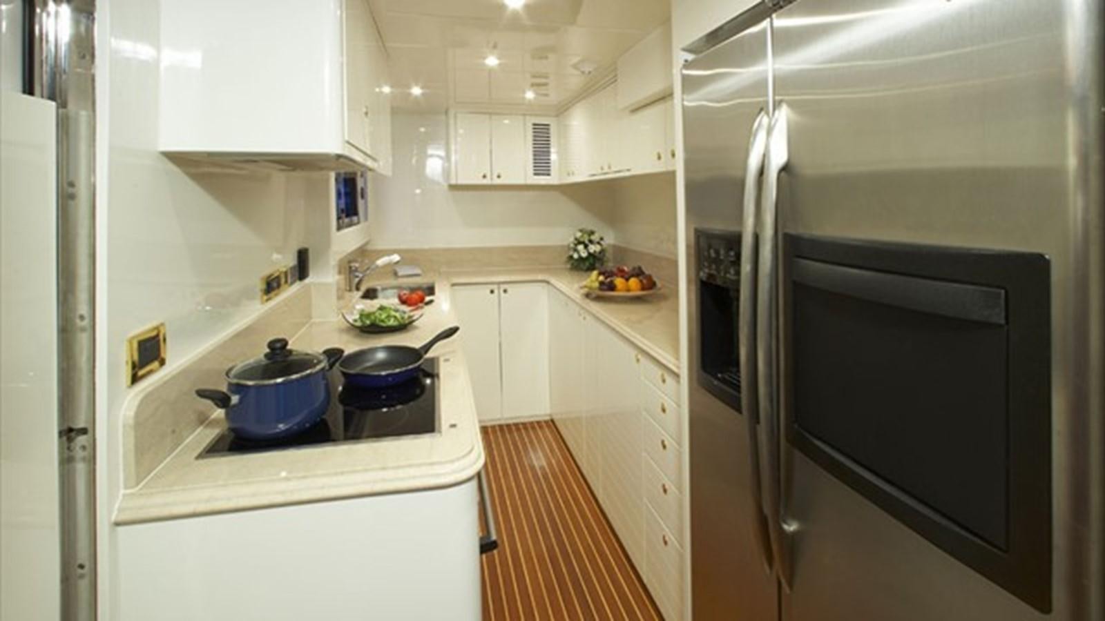 a kitchen with white cabinets aboard JOHNSON 93 SKYLOUNGE Yacht for Sale