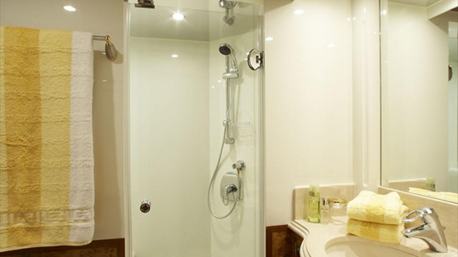 a bathroom with a shower curtain aboard JOHNSON 93 SKYLOUNGE Yacht for Sale