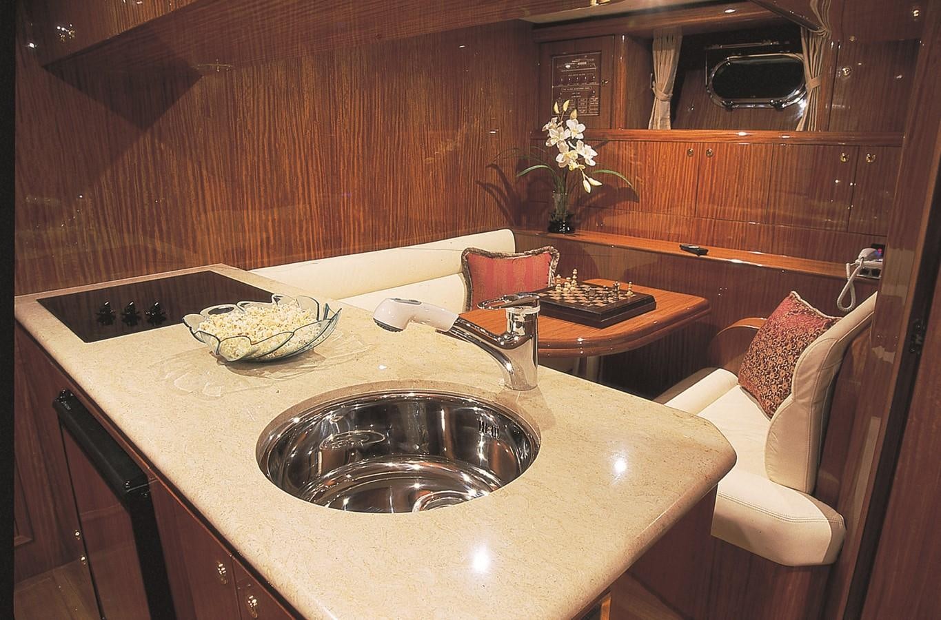 a kitchen sink with a bowl of food on it aboard JOHNSON 93 SKYLOUNGE Yacht for Sale