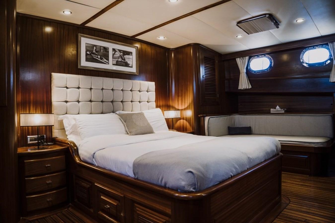 a large bed in a room aboard CAPRICORN 1 Yacht for Sale