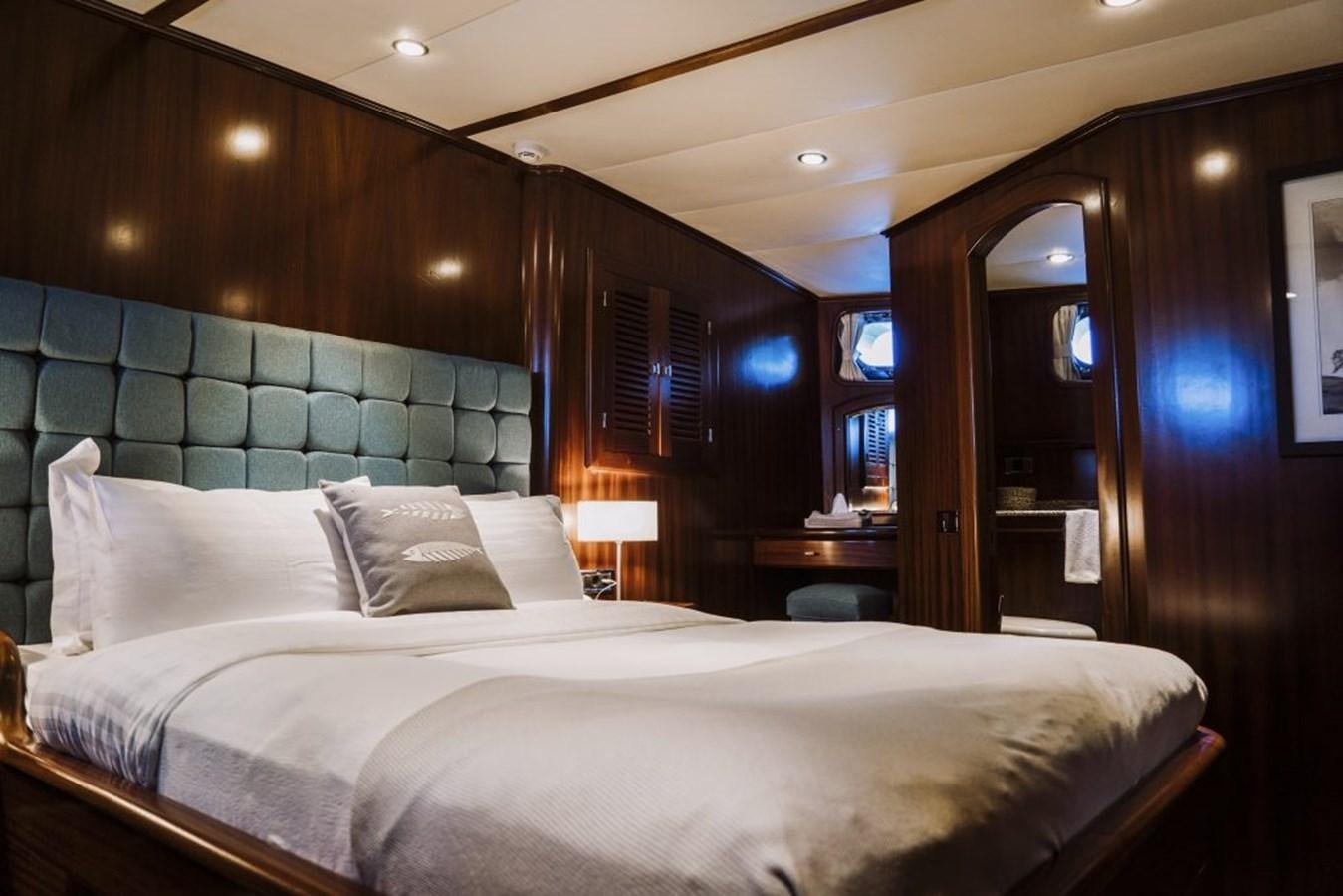 a bed with a white sheet aboard CAPRICORN 1 Yacht for Sale