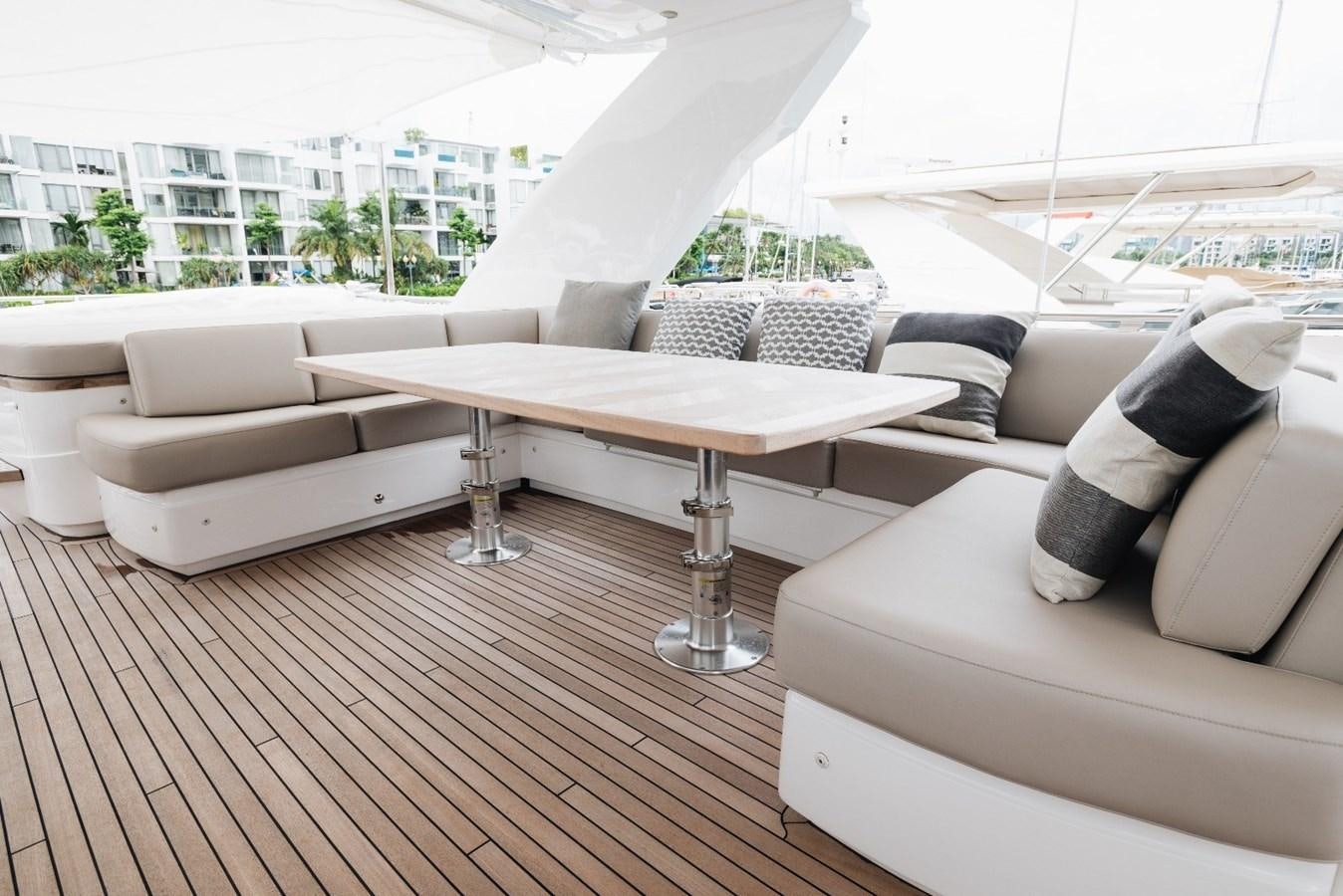 a living room with a table and couches aboard ISLAND PRINCESS Yacht for Sale
