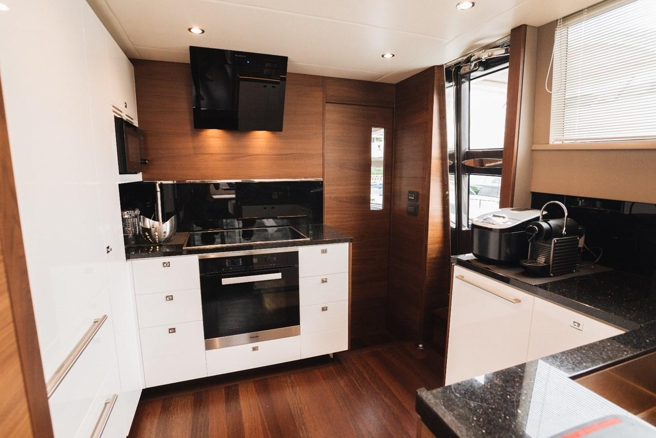 a kitchen with white cabinets aboard ISLAND PRINCESS Yacht for Sale