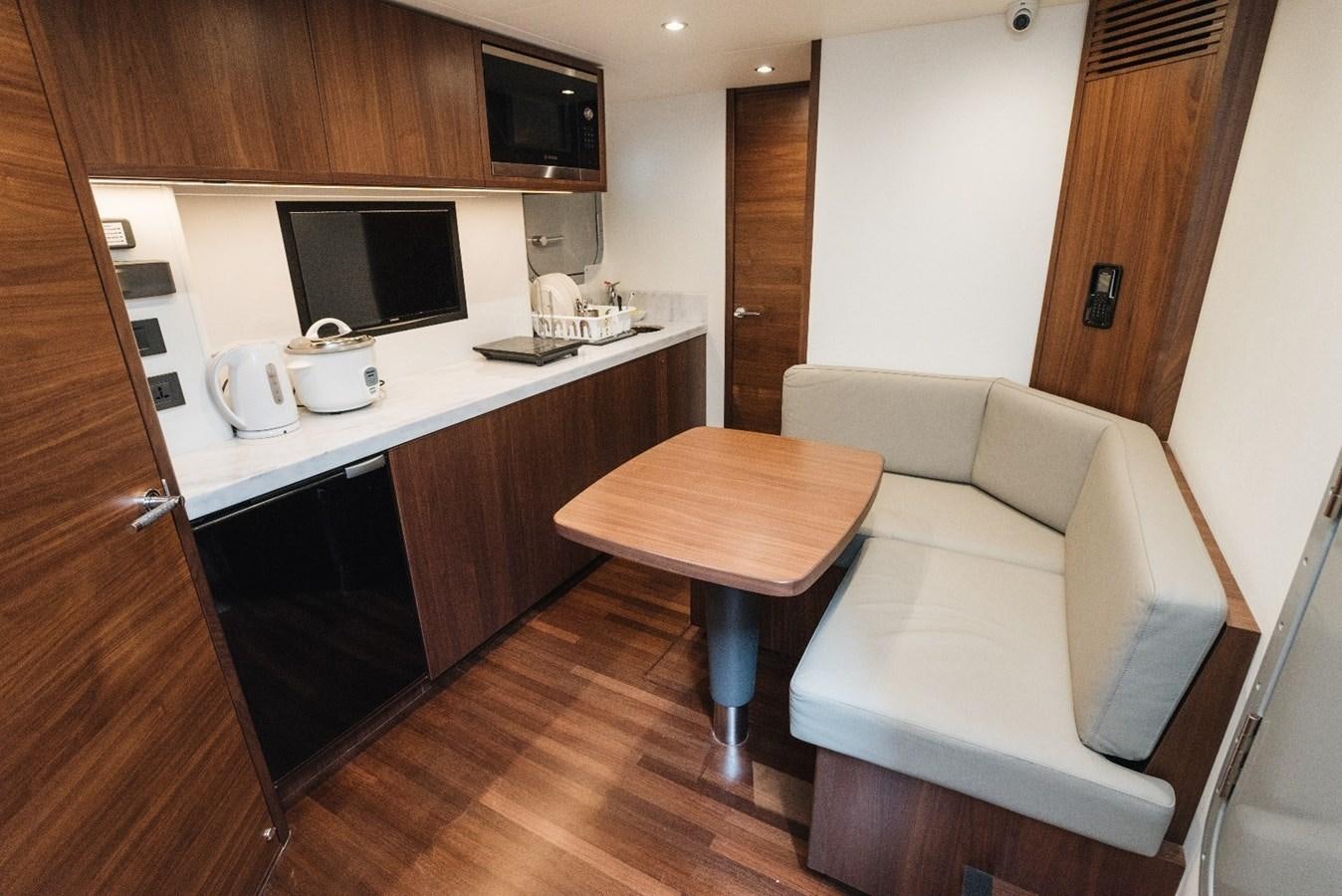 a small living room with a small table and tv aboard ISLAND PRINCESS Yacht for Sale
