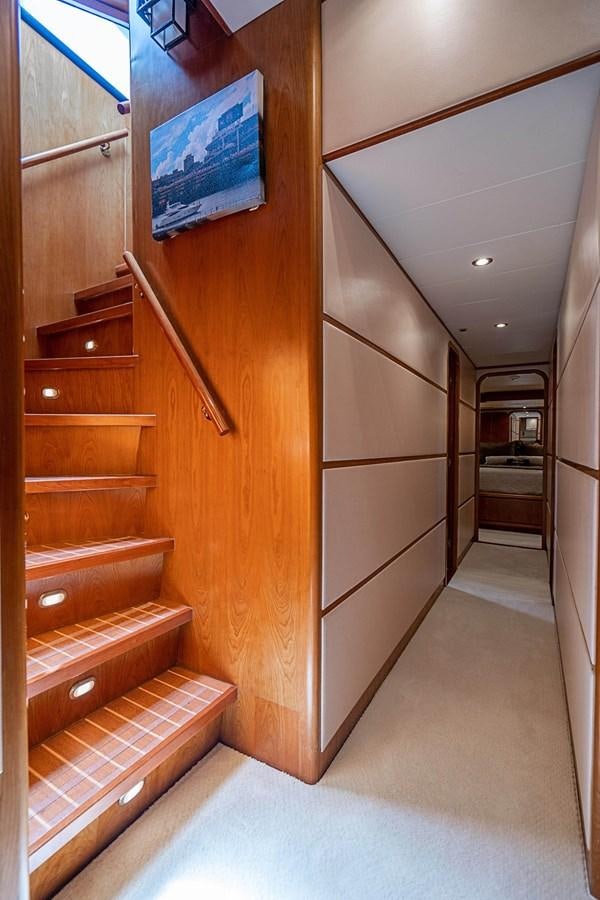 a wood staircase in a room aboard ROXY MARIA Yacht for Sale