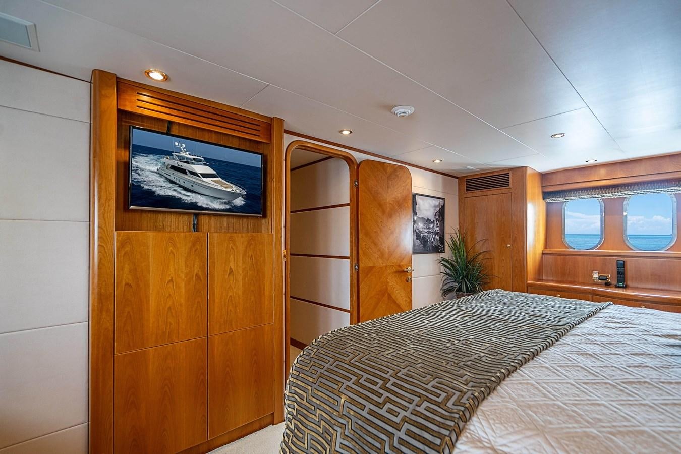 a bedroom with a bed and a closet aboard ROXY MARIA Yacht for Sale
