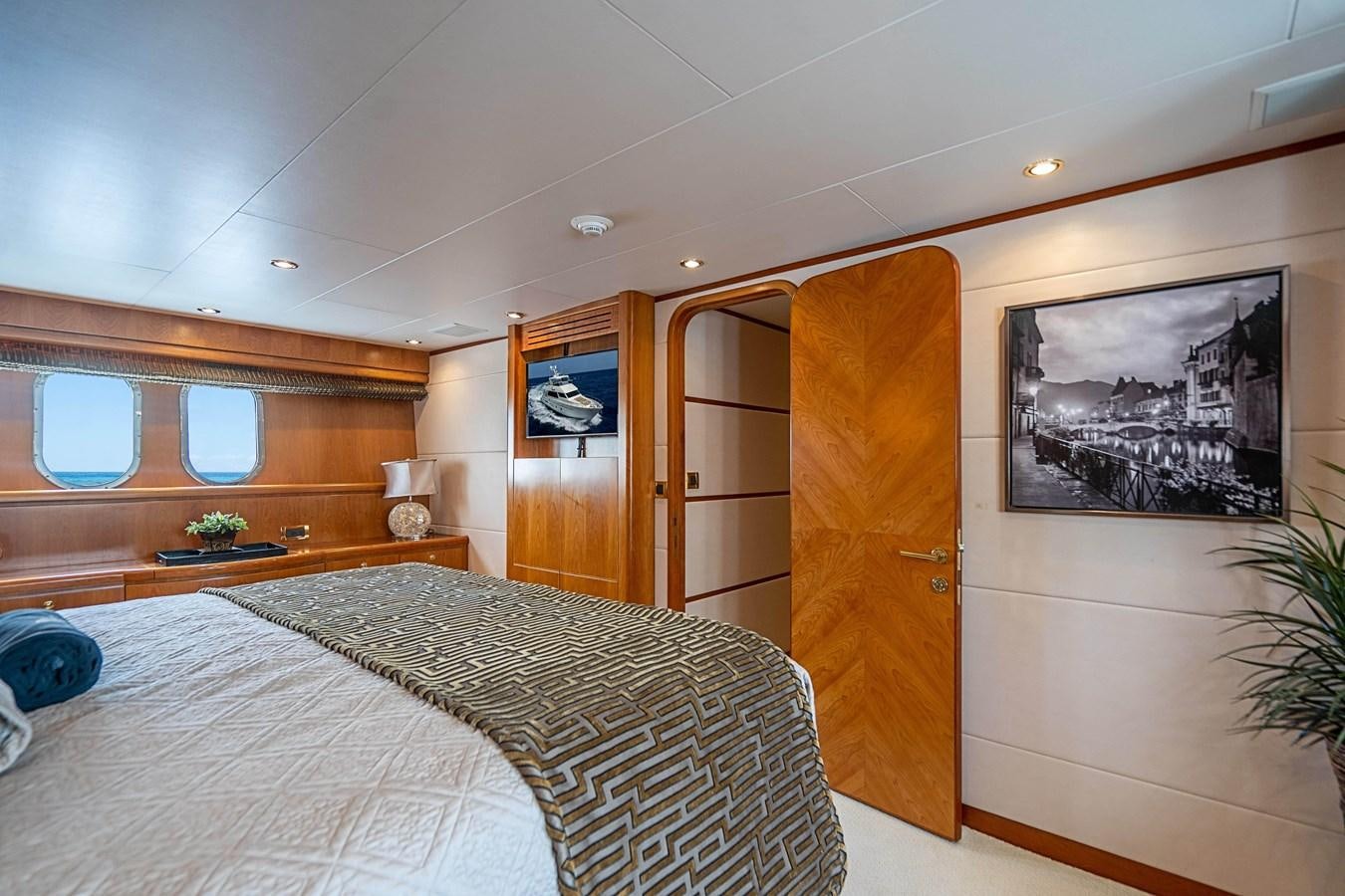 a bedroom with a bed and a door aboard ROXY MARIA Yacht for Sale