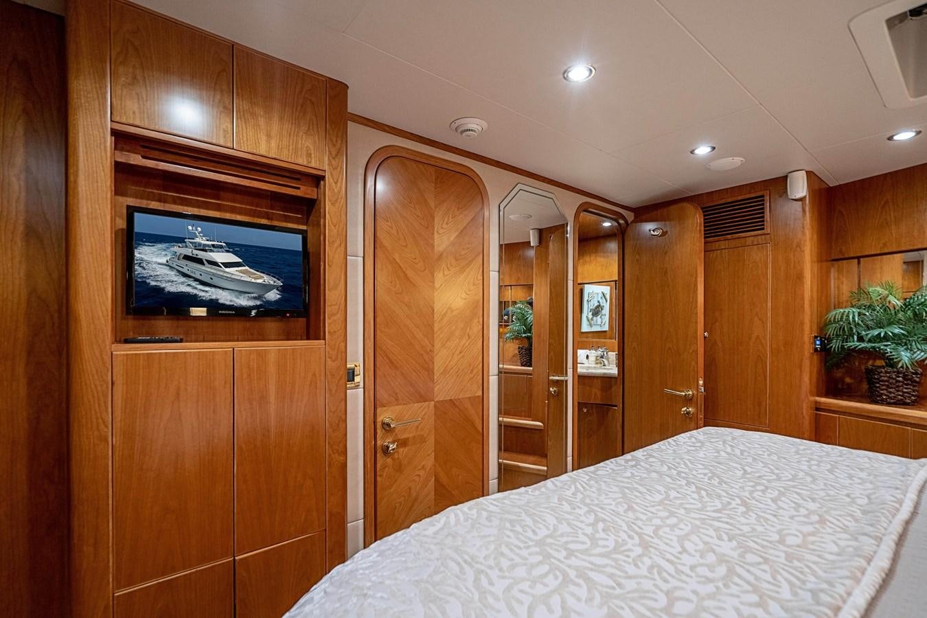 a bedroom with a bed and a closet aboard ROXY MARIA Yacht for Sale