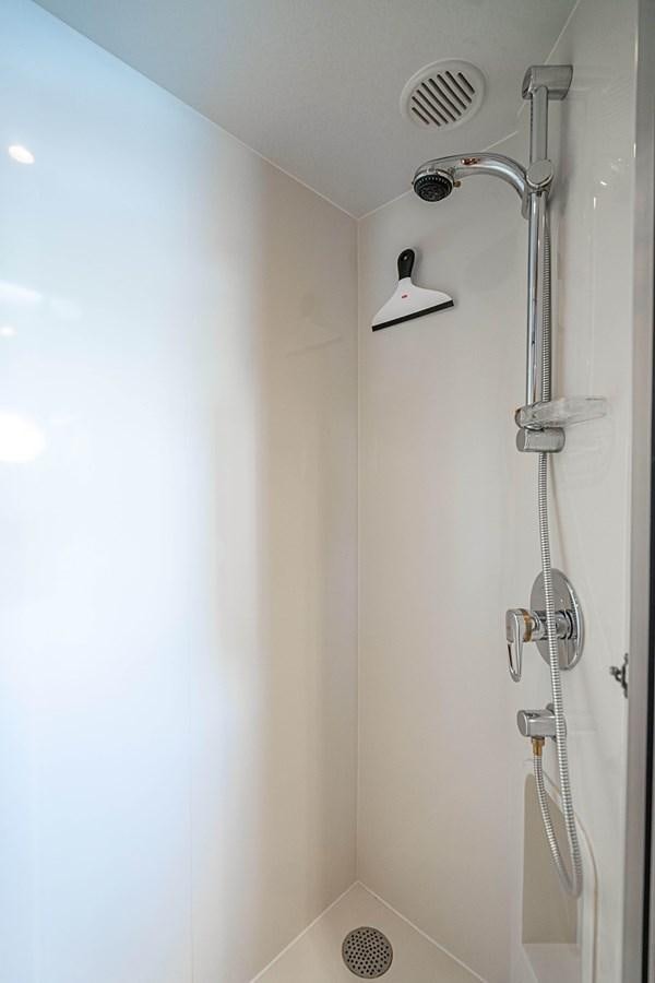 a shower with a light on the wall aboard ROXY MARIA Yacht for Sale
