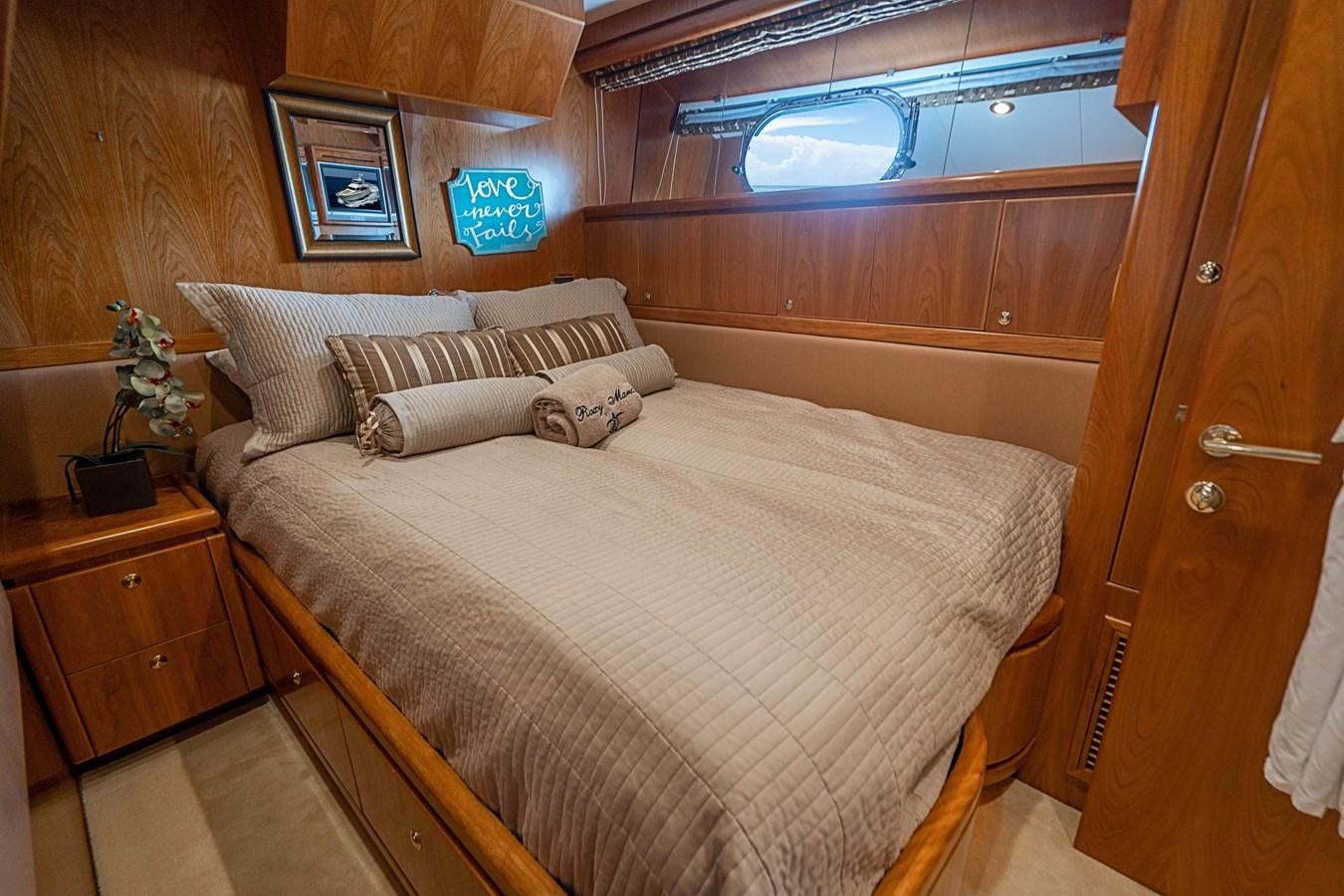 a bed with a white comforter aboard ROXY MARIA Yacht for Sale